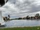 Scenic waterfront view with a sailboat on the lake and houses in the background, enhancing the community's appeal at 3005 Treasure Island Rd, Las Vegas, NV 89128