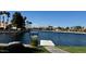 Picturesque waterfront view featuring a community sign and nearby houses, enhancing the neighborhood's appeal at 3005 Treasure Island Rd, Las Vegas, NV 89128
