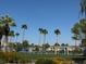 Scenic waterfront view showcasing community amenities with palm trees, nearby houses, and recreational spaces enhancing the property's appeal at 3005 Treasure Island Rd, Las Vegas, NV 89128