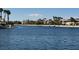 Beautiful waterfront view surrounded by lush greenery, palm trees, and nearby houses, enhancing the community setting at 3005 Treasure Island Rd, Las Vegas, NV 89128