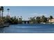 Beautiful waterfront featuring a bridge, lush trees, and nearby houses, creating a picturesque community setting at 3005 Treasure Island Rd, Las Vegas, NV 89128