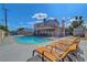 Large backyard with a sparkling pool and comfortable lounge chairs; great outdoor entertainment space at 3018 Burnham Ave, Las Vegas, NV 89169