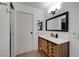 Bathroom with light wood vanity, decorative mirror, and white countertops at 3018 Burnham Ave, Las Vegas, NV 89169