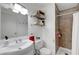 Clean bathroom featuring a shower, sink, vanity and decorative shelving at 3018 Burnham Ave, Las Vegas, NV 89169
