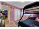 Bright bedroom featuring wood-look flooring and hallway access at 3018 Burnham Ave, Las Vegas, NV 89169