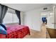 Comfortable bedroom with wood-look flooring, natural light and an open doorway at 3018 Burnham Ave, Las Vegas, NV 89169