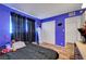 Vibrant blue bedroom with wood-look flooring, closet doors, and natural lighting at 3018 Burnham Ave, Las Vegas, NV 89169