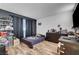 Bright bedroom showcasing wood-look floors and ample storage with dark accents at 3018 Burnham Ave, Las Vegas, NV 89169