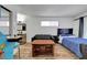 Bedroom with a bed, couch, arcade game, wood floors, and natural light at 3018 Burnham Ave, Las Vegas, NV 89169