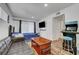 Bedroom with a TV, arcade game, couch, wood floors, and large window at 3018 Burnham Ave, Las Vegas, NV 89169