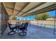 Relaxing covered patio with an outdoor table and chairs, perfect for entertaining by the pool at 3018 Burnham Ave, Las Vegas, NV 89169