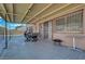 Spacious covered patio features secure window and door bars, adjacent to a private backyard at 3018 Burnham Ave, Las Vegas, NV 89169