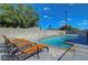Backyard features a sparkling pool and comfortable lounge chairs, perfect for relaxation and sunny days at 3018 Burnham Ave, Las Vegas, NV 89169