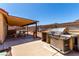 Well-equipped backyard with covered patio, outdoor kitchen, and BBQ grill, perfect for entertaining at 307 Oak Canyon Dr, Henderson, NV 89015