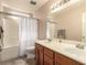 Bathroom featuring a double vanity, tub with shower, and tiled flooring, designed for functionality at 307 Oak Canyon Dr, Henderson, NV 89015