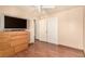 Bedroom featuring a TV, dresser, wood floors, and white ceiling fan at 307 Oak Canyon Dr, Henderson, NV 89015