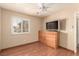 Bright bedroom with a window, ceiling fan, and wood floors, offering comfortable living space at 307 Oak Canyon Dr, Henderson, NV 89015