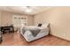 Well-lit bedroom with wood floors, tray ceiling, and desk near window at 307 Oak Canyon Dr, Henderson, NV 89015