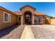 Front entrance with stone columns, arched entry, and a well-lit doorway at 307 Oak Canyon Dr, Henderson, NV 89015
