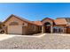 Well-maintained single-story home with a two-car garage and arched entryway at 307 Oak Canyon Dr, Henderson, NV 89015
