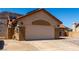 Single-story home with a two-car garage and terracotta roof against a mountain backdrop at 307 Oak Canyon Dr, Henderson, NV 89015