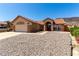 Inviting single-story home with arched entry and xeriscaped front yard at 307 Oak Canyon Dr, Henderson, NV 89015