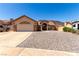 Charming single-story home with a spacious driveway and desert landscaping at 307 Oak Canyon Dr, Henderson, NV 89015