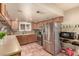 Cozy kitchen featuring stainless steel appliances and terracotta tile flooring at 307 Oak Canyon Dr, Henderson, NV 89015
