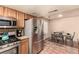 Modern kitchen boasts stainless steel appliances, terracotta flooring and adjacent dining area at 307 Oak Canyon Dr, Henderson, NV 89015