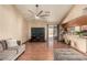 Spacious living room with wood floors, ceiling fan, and access to the backyard through sliding glass doors at 307 Oak Canyon Dr, Henderson, NV 89015