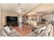 Open-concept living room with hardwood floors seamlessly connect to the kitchen with stainless steel appliances at 307 Oak Canyon Dr, Henderson, NV 89015
