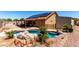 Backyard oasis with a rock-lined pool, lush landscaping, and outdoor storage shed, creating a serene retreat at 307 Oak Canyon Dr, Henderson, NV 89015