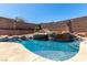 Refreshing pool featuring a unique rock waterfall, enhancing the backyard's appeal, designed for relaxation at 307 Oak Canyon Dr, Henderson, NV 89015