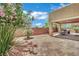 Cozy backyard with a covered patio and dining set surrounded by lush greenery at 3217 Bonassola Ave, North Las Vegas, NV 89031