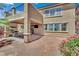 Beautiful outdoor living space with a covered patio, TV, dining set, and lush plants at 3217 Bonassola Ave, North Las Vegas, NV 89031