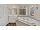 Bathroom featuring soaking tub, quartz countertops, and modern fixtures at 3217 Bonassola Ave, North Las Vegas, NV 89031