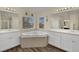 Bathroom featuring soaking tub, dual sinks, quartz countertops, and modern fixtures at 3217 Bonassola Ave, North Las Vegas, NV 89031