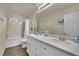 Bathroom with dual sinks, granite countertops, and shower-tub combination at 3217 Bonassola Ave, North Las Vegas, NV 89031