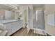 Bathroom featuring walk-in shower with glass enclosure, quartz countertops, and modern fixtures at 3217 Bonassola Ave, North Las Vegas, NV 89031