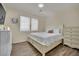 Cozy bedroom with neutral tones, hardwood floors, bright natural lighting, and a dresser at 3217 Bonassola Ave, North Las Vegas, NV 89031