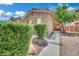 Charming home featuring stone accents and mature landscaping for curb appeal at 3217 Bonassola Ave, North Las Vegas, NV 89031