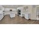 Bright, open kitchen with white cabinetry, stainless steel appliances, an island, and hardwood floors at 3217 Bonassola Ave, North Las Vegas, NV 89031
