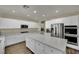 Bright kitchen with modern appliances, white cabinets, and a large center island at 3217 Bonassola Ave, North Las Vegas, NV 89031