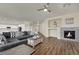 Open-concept living room featuring hardwood floors, neutral paint, a fireplace, and a view into the kitchen at 3217 Bonassola Ave, North Las Vegas, NV 89031