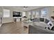 Spacious living room with hardwood floors, neutral paint, fireplace, and lots of natural light at 3217 Bonassola Ave, North Las Vegas, NV 89031