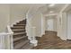 Elegant staircase with carpeted steps and white banister railing in a bright, open foyer at 3217 Bonassola Ave, North Las Vegas, NV 89031