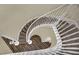 View of a winding staircase with wooden treads and white railing at 3217 Bonassola Ave, North Las Vegas, NV 89031