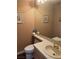 Powder room with tile countertop, wall mirror, and textured walls at 3394 Brookfield Dr, Las Vegas, NV 89120
