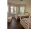 Bedroom with two beds and bright natural lighting from multiple windows at 3394 Brookfield Dr, Las Vegas, NV 89120