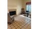 Living room featuring tile floors, brick fireplace, and natural light at 3394 Brookfield Dr, Las Vegas, NV 89120